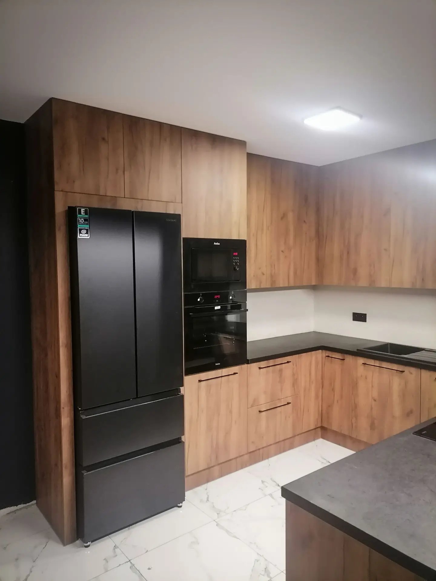 Kuchnia w drewnie z czarnymi akcentami